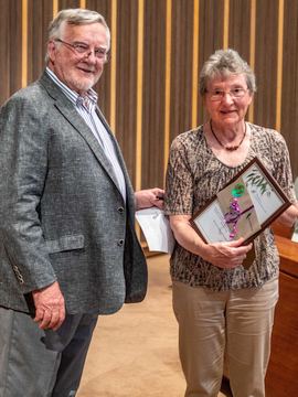 Lesley Harland receives her award from Max Bourke