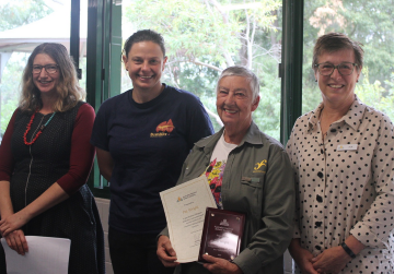 Pat Wright receiving her certificate for 25 years of volunteering