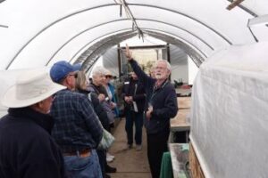 Maurice Hermann showing Friends the Growing Friends 'igloo'